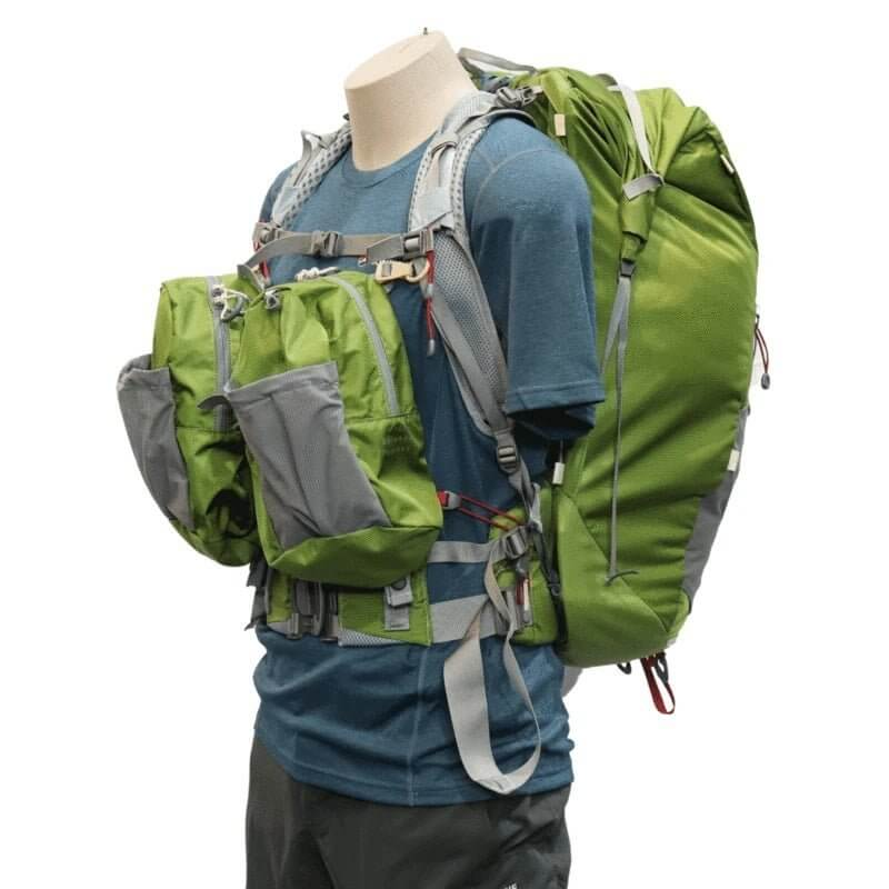a mannequin wearing a green Aarn backpack 